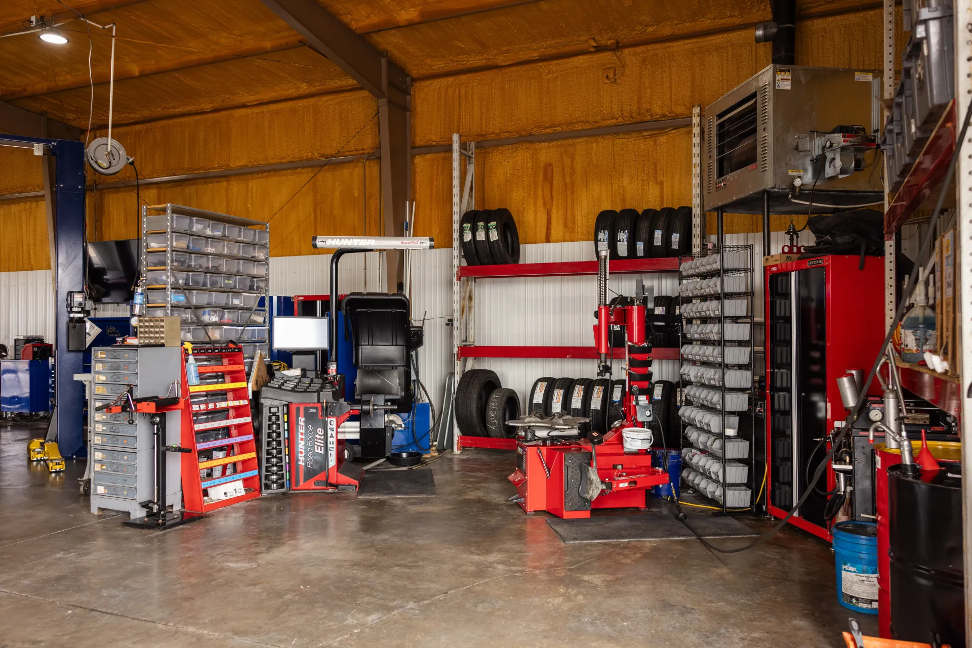 Auto Repair Shop with Shelves of Tools, Tires, and Equipment | Craig Automotive Services