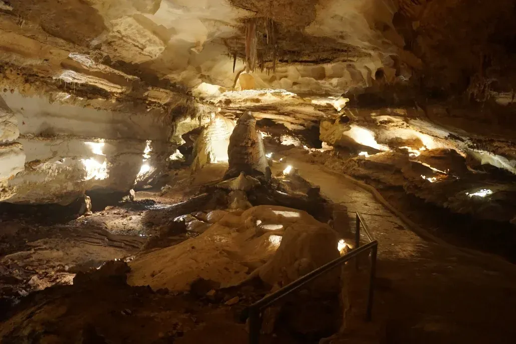 A large cave with a fence in the middle of it