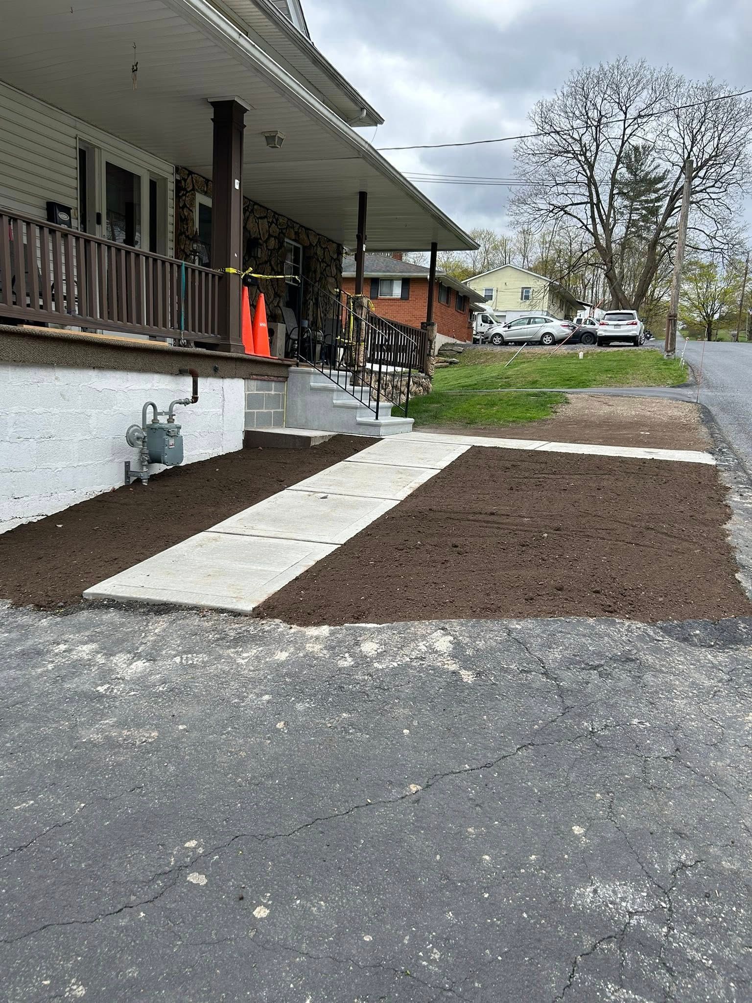 Residential site work near porch and walkway
