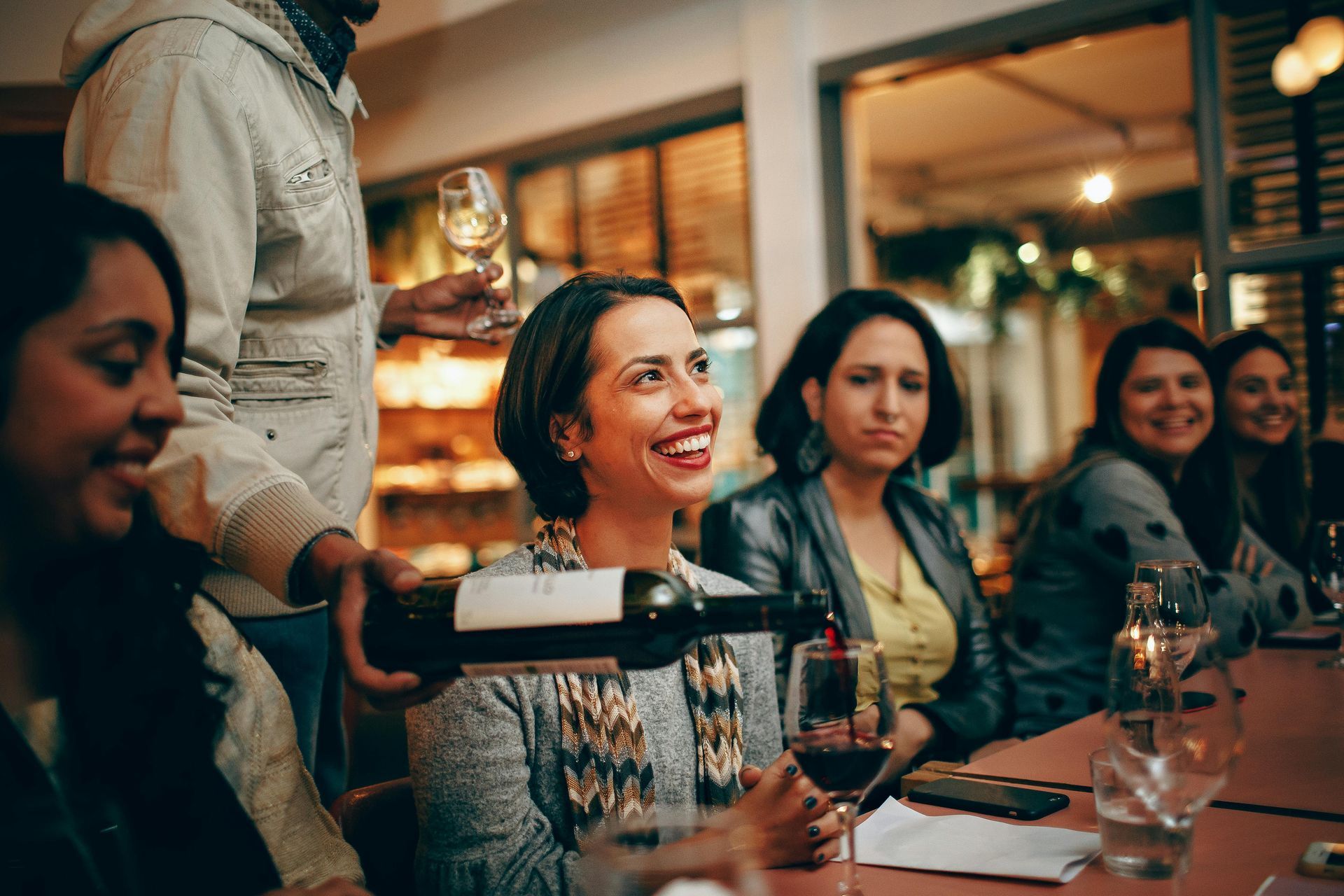 A group of people are sitting at a table in a restaurant - Busy Vegan Blog
