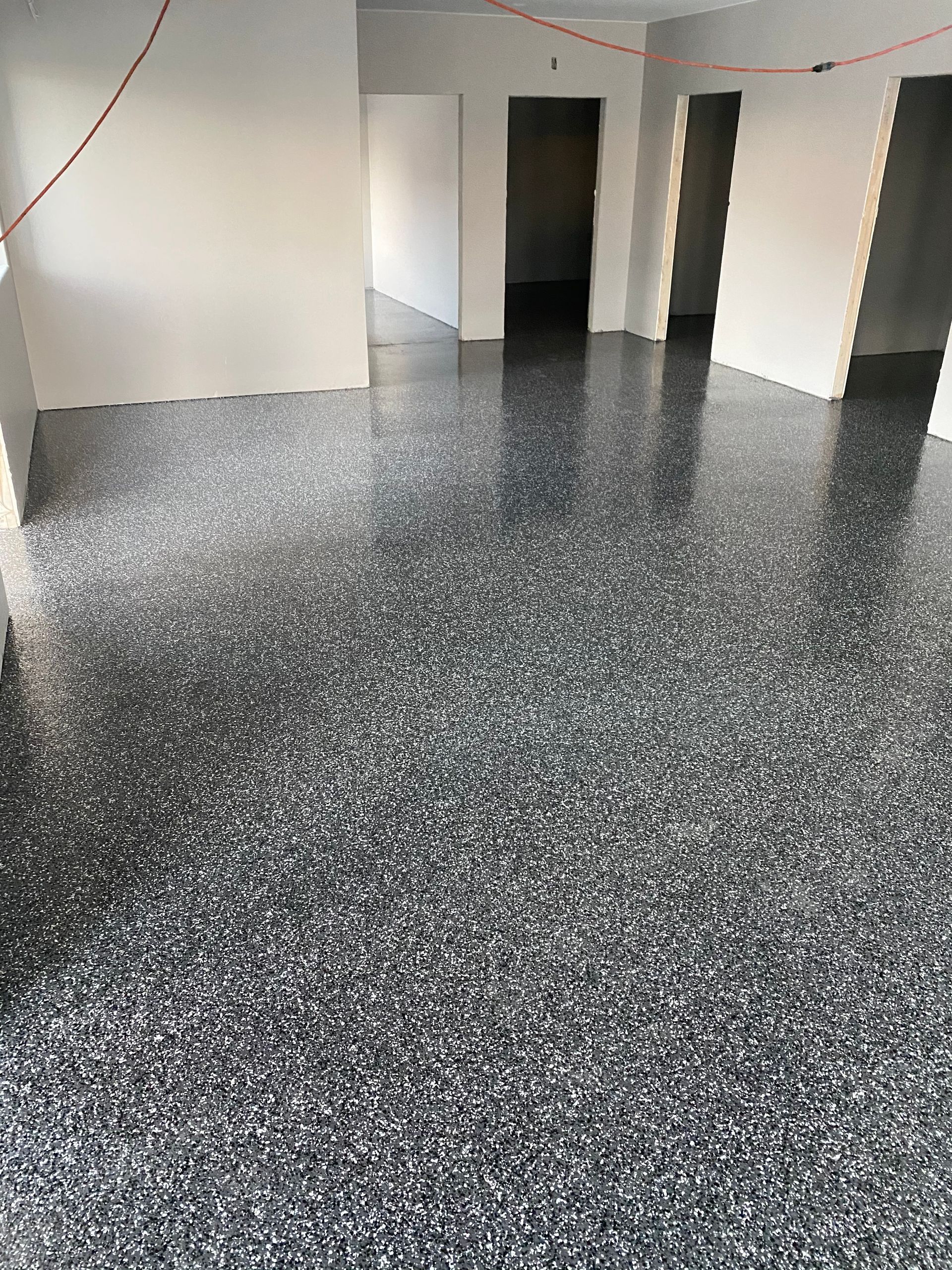 A large room with a gray floor and white walls.