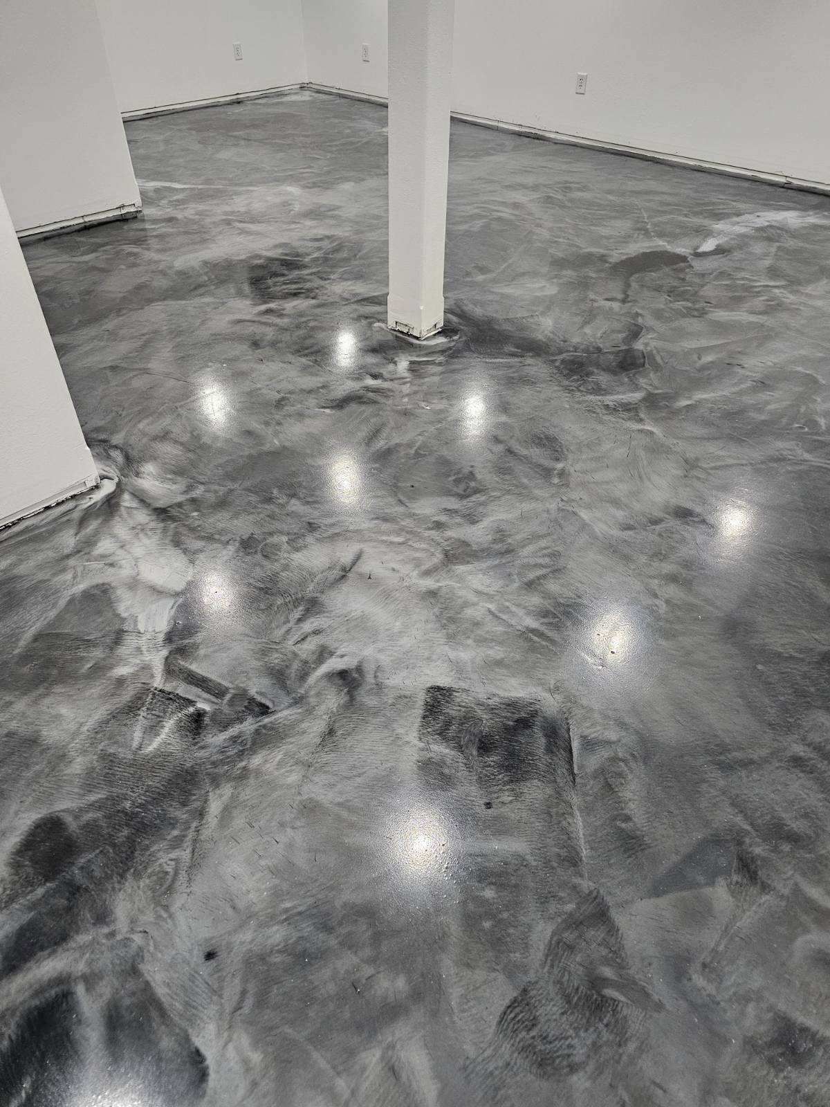 A garage with a gray floor and white walls.