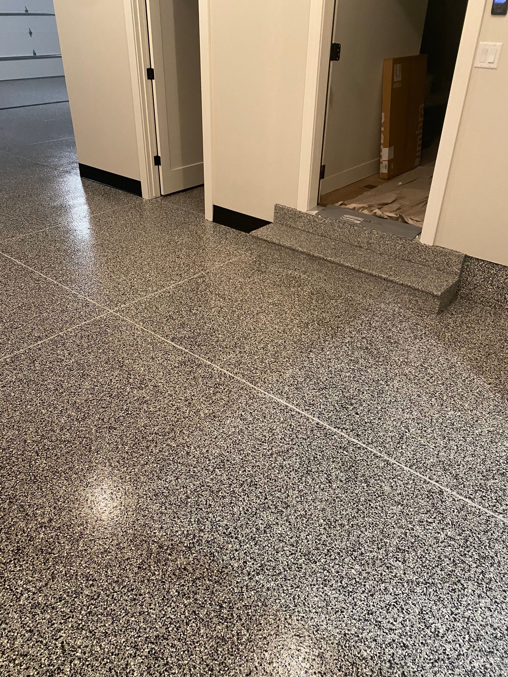 A garage with a shiny floor and two garage doors.
