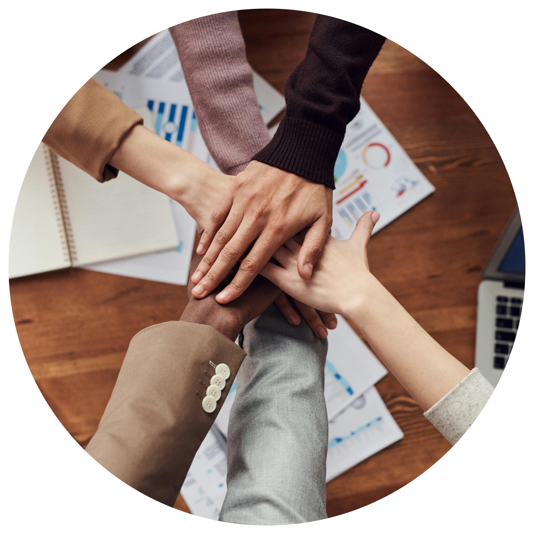 A group of people putting their hands together in a circle