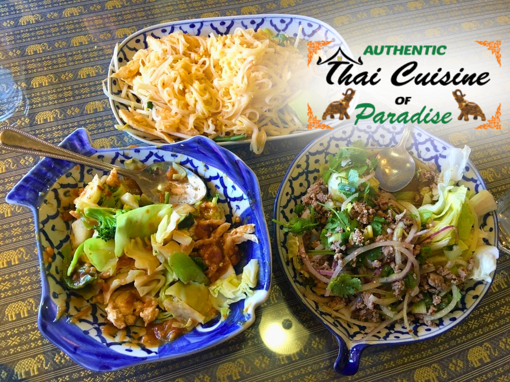 Three Thai dishes in colorful bowls with green garnish on a patterned tablecloth