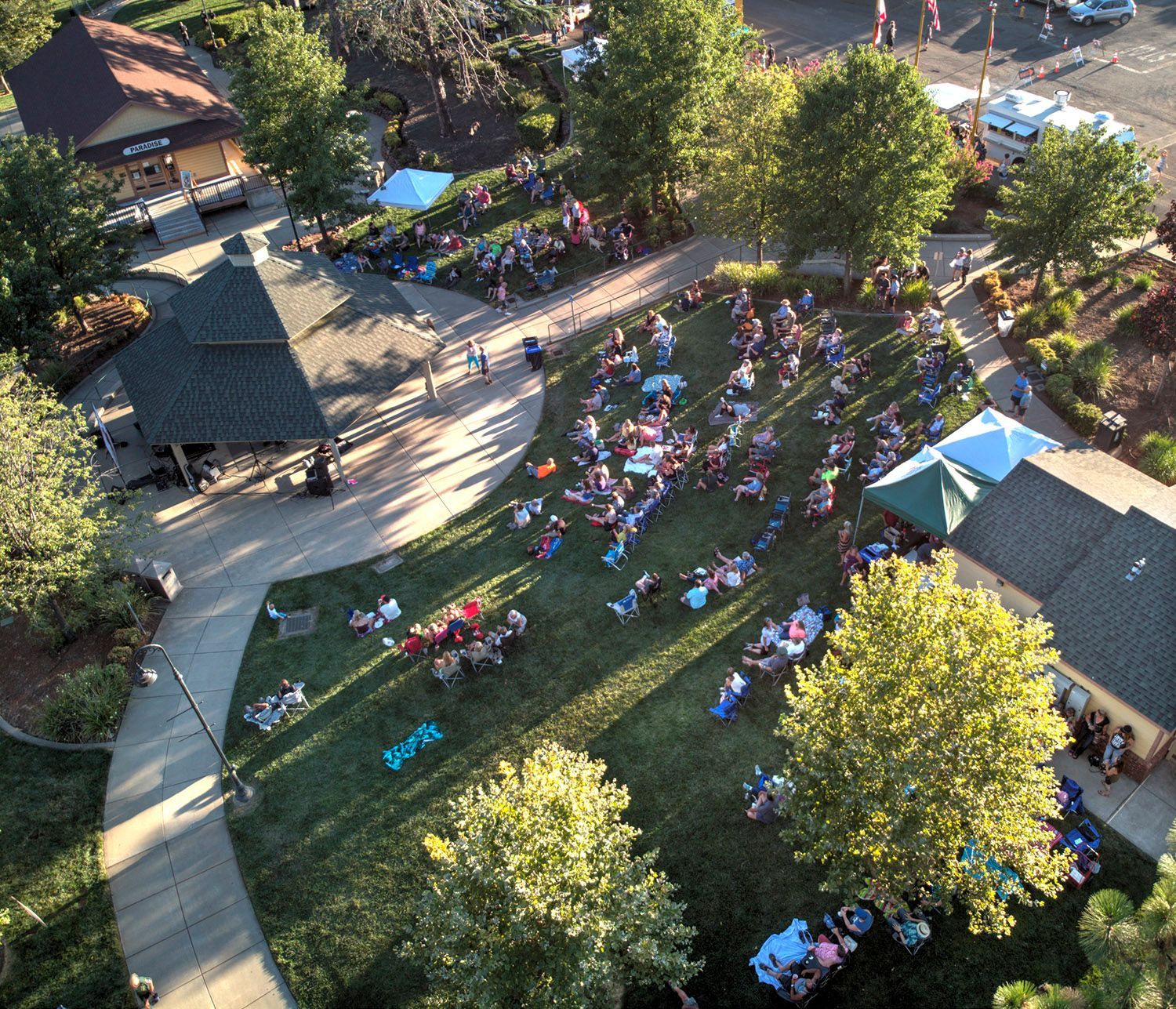 An aerial view of a park with people sitting on the grass in Paradise and Magalia, California