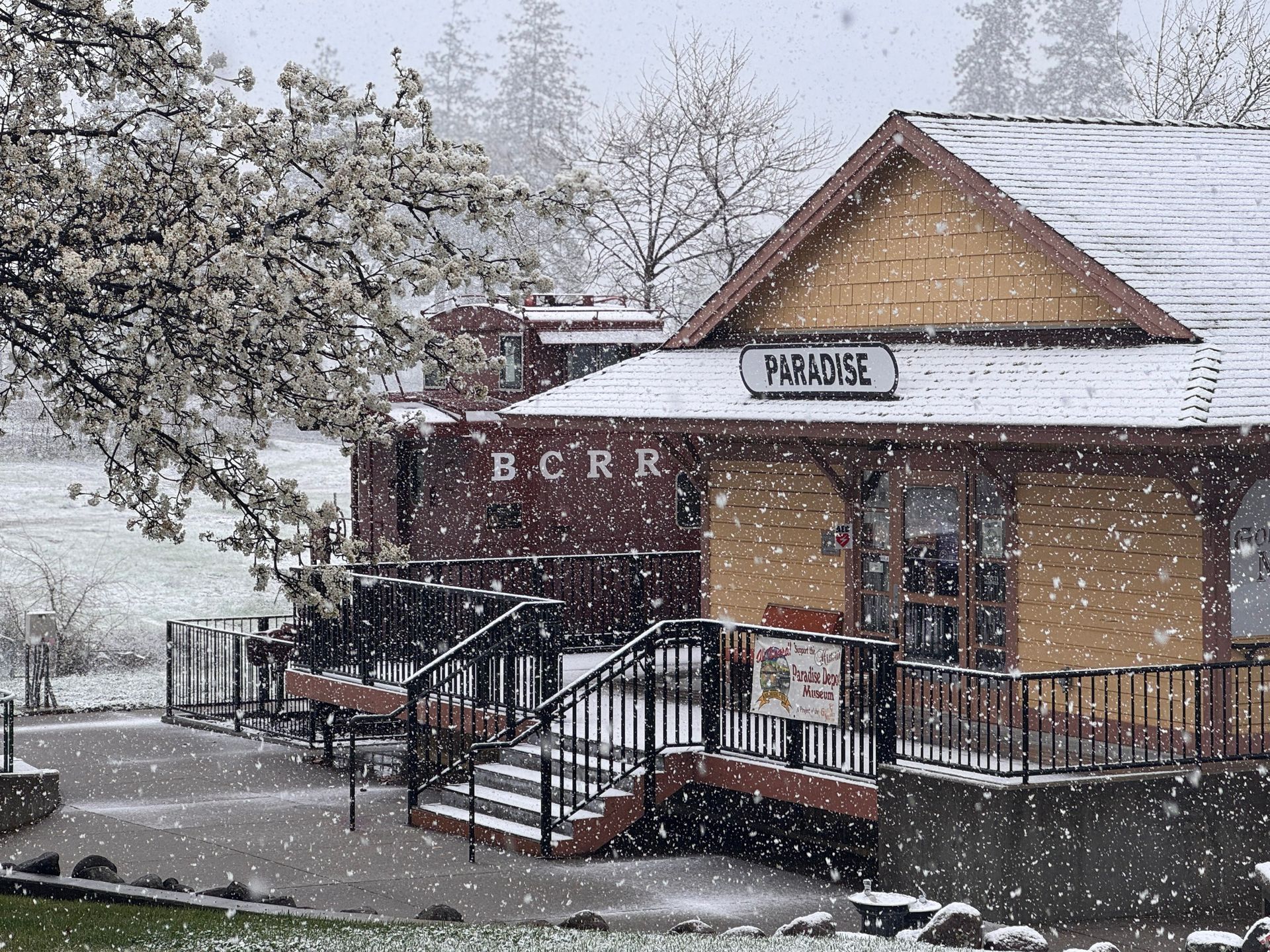 Snow-covered historic train depot with