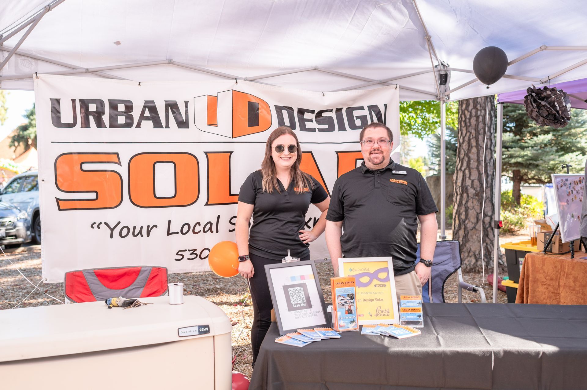 Paradise Animal Shelter Helpers booth with volunteers and pet supplies at an outdoor event