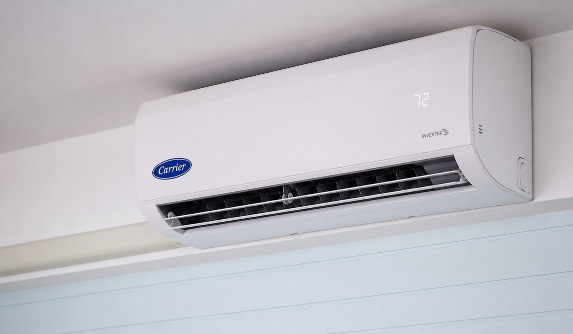 White wall-mounted air conditioner near the ceiling in a room