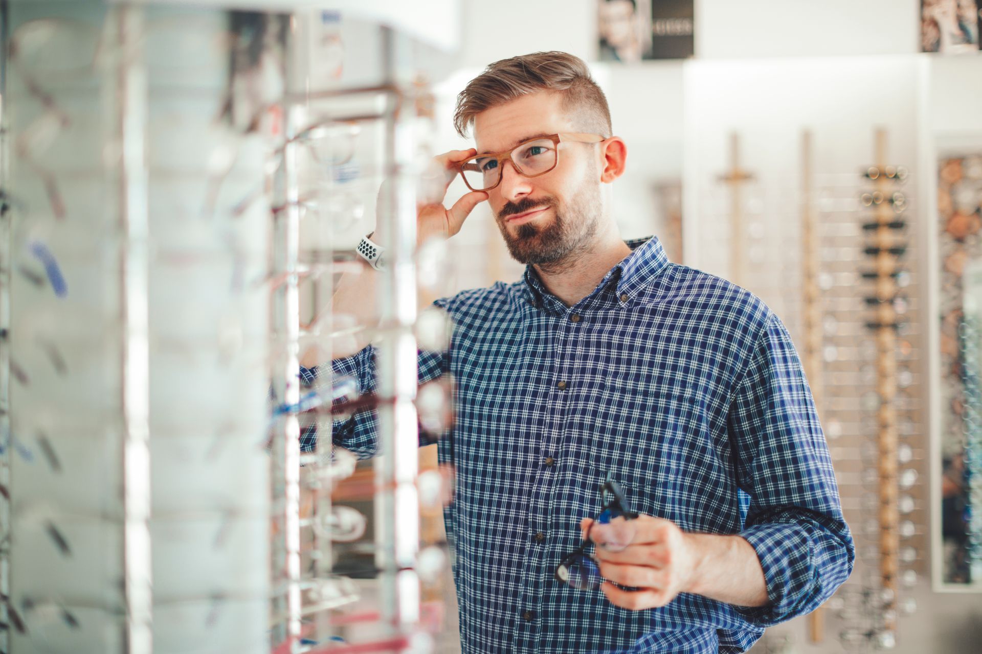 Man Choosing An Eyeglass — Lincoln, NE — Optical Gallery
