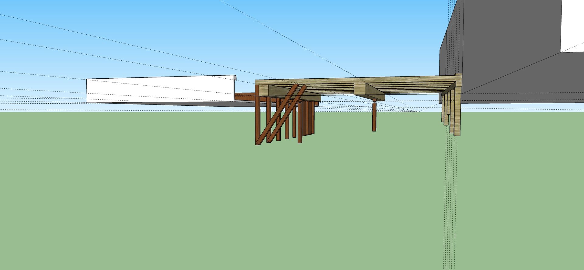 Een houten constructie met een lichtblauwe lucht en een groene grond.
