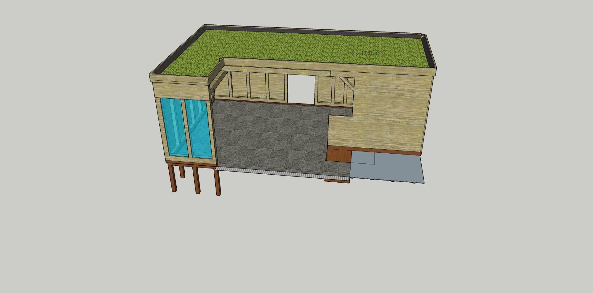 Een klein gebouw met een groen dak, ramen en houten steunbalken.