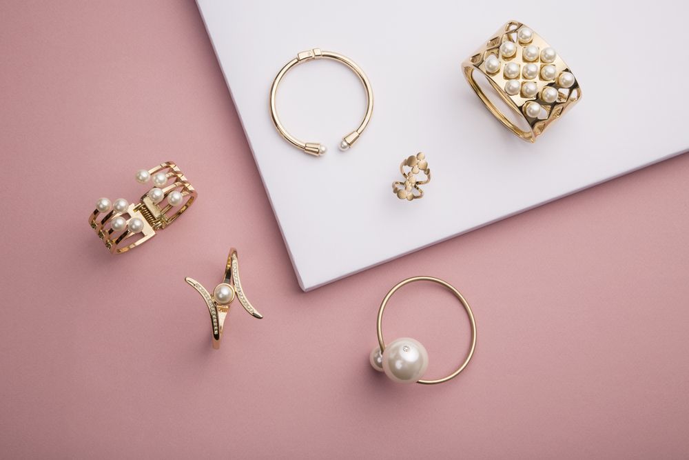 Gold Rings and Earrings Arranged on Pink and White Surfaces — Tilligerry Collective in Tilligerry Peninsula, NSW