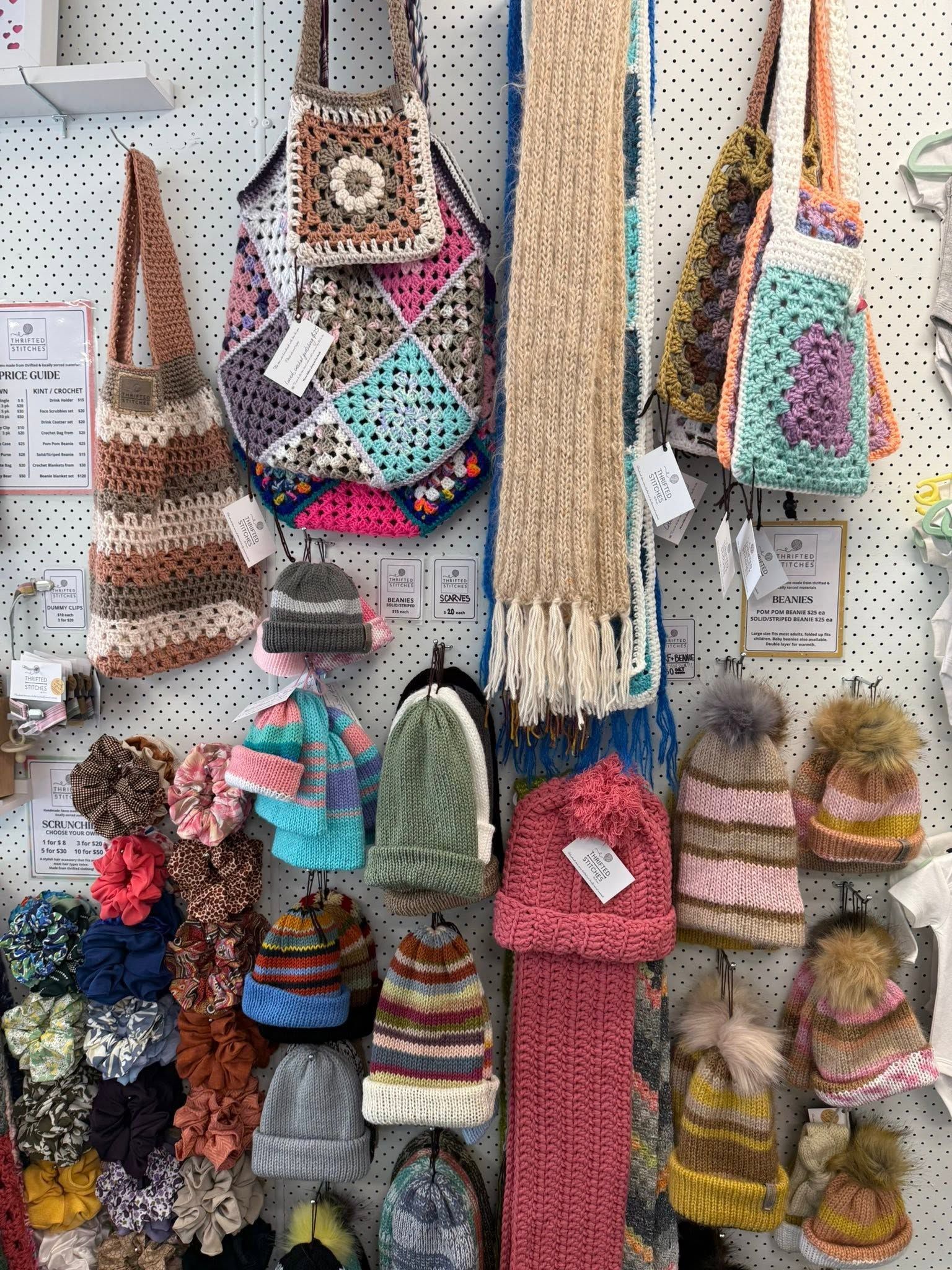 Crocheted Bags, Hats, Scarves, and Accessories Hanging on a Craft Display Wall — Tilligerry Collective in Tilligerry Peninsula, NSW