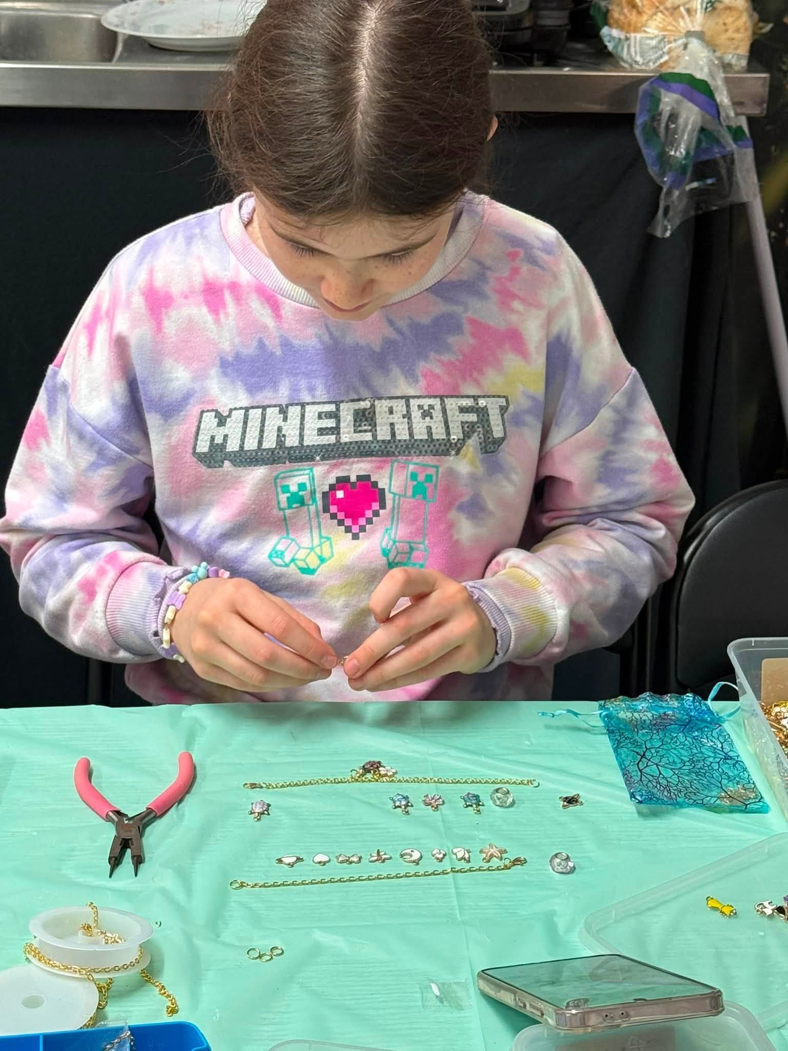 Person in a Minecraft Sweatshirt Making Crafts at a Turquoise Table — Tilligerry Collective in Tilligerry Peninsula, NSW