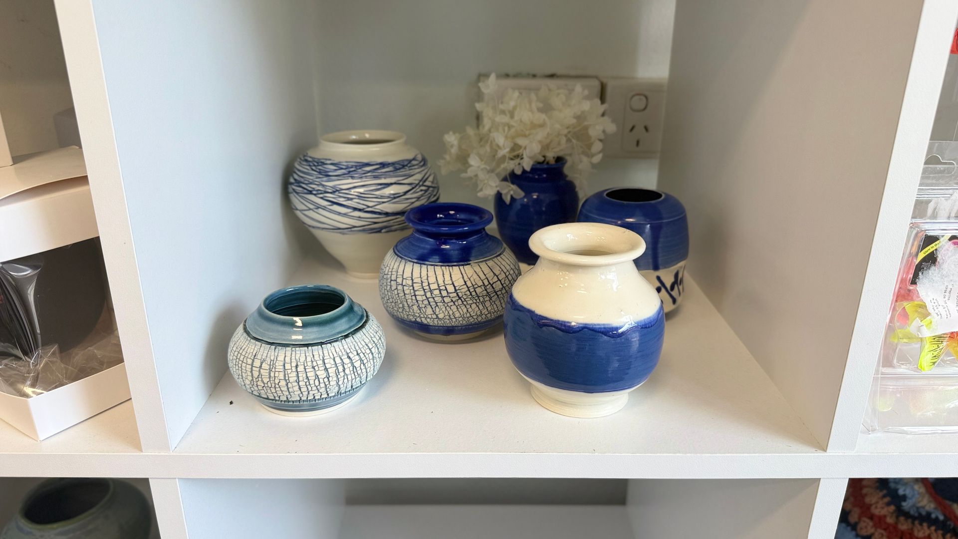 Blue-and-white ceramic jars and bowls displayed on a white shelf. — Tilligerry Collective in Tilligerry Peninsula, NSW