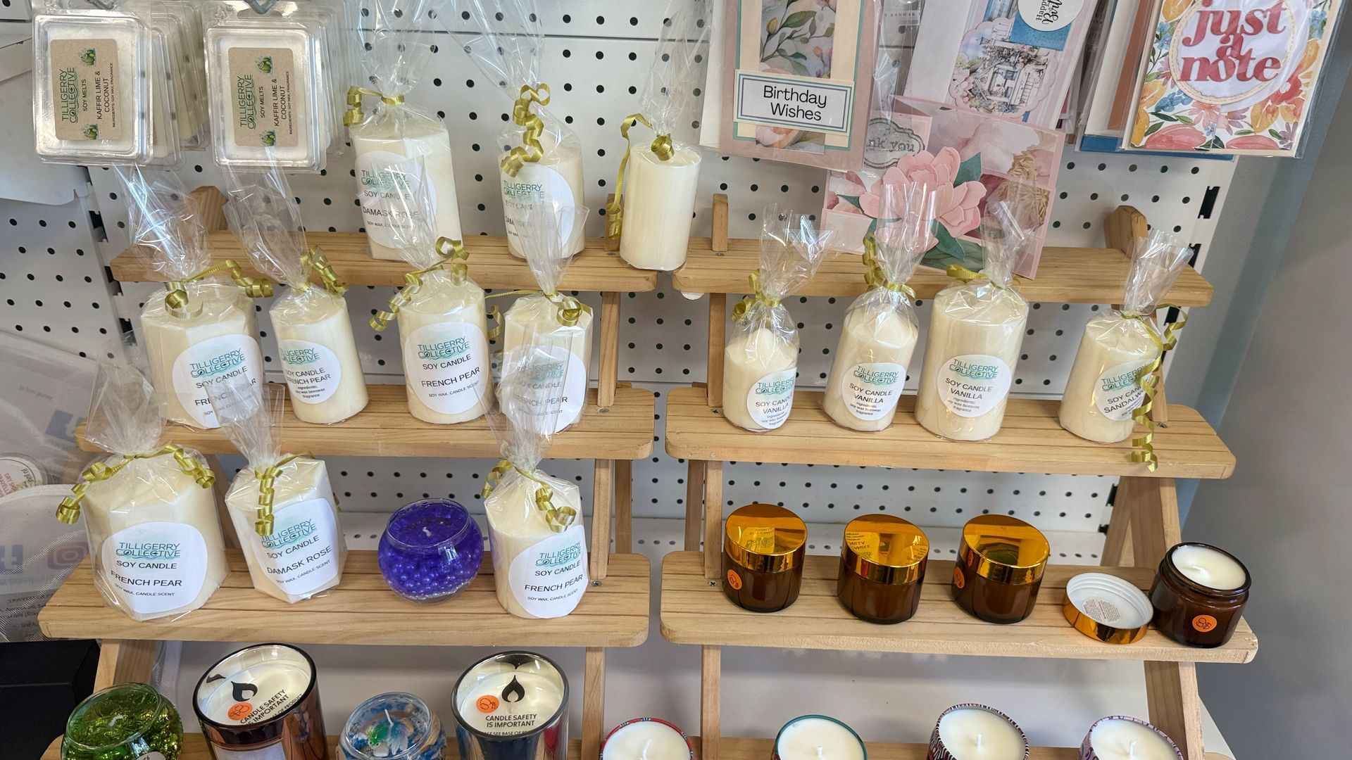 Shelved display of assorted candles and decorative jars in a shop aisle — Tilligerry Collective in Tilligerry Peninsula, NSW