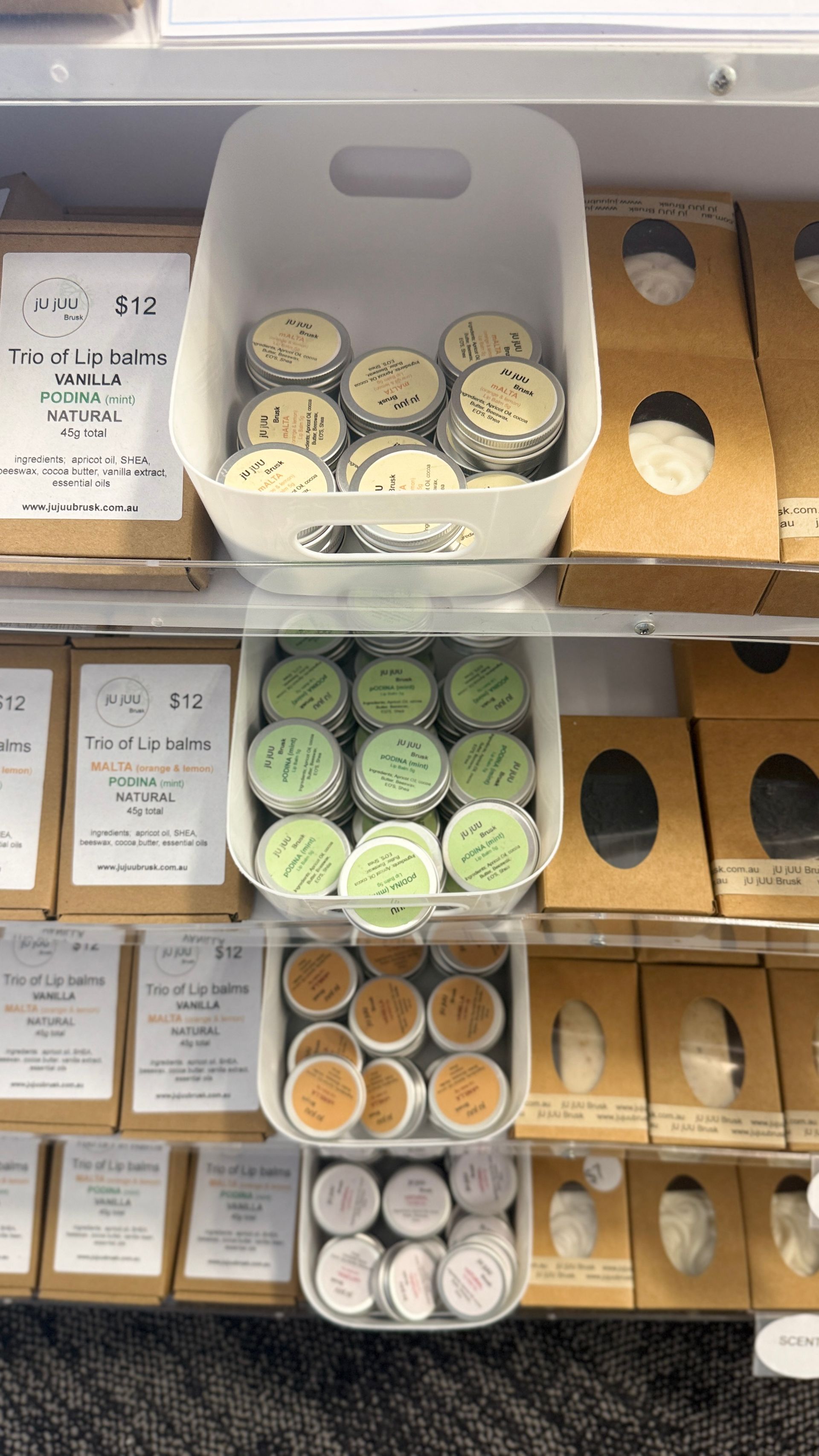 Open shelf of assorted packaged pastries and desserts in white boxes and cups. — Tilligerry Collective in Tilligerry Peninsula, NSW