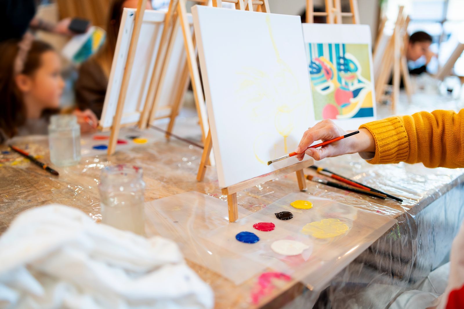 Children Painting at Easels During a Colourful Art Activity — Tilligerry Collective in Tilligerry Peninsula, NSW