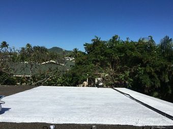 A close up of a black roof with a white background.