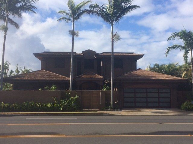 A large house with palm trees in front of it