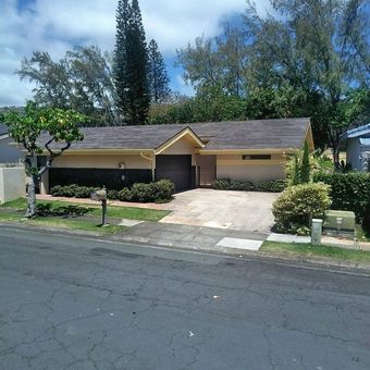 A house with a palm tree in front of it