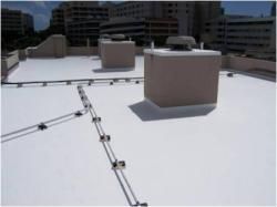 A white roof with a chimney on top of it.