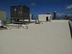 The roof of a building with a cooling tower on top of it.