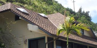 A close up of a roof with a lot of shingles on it.
