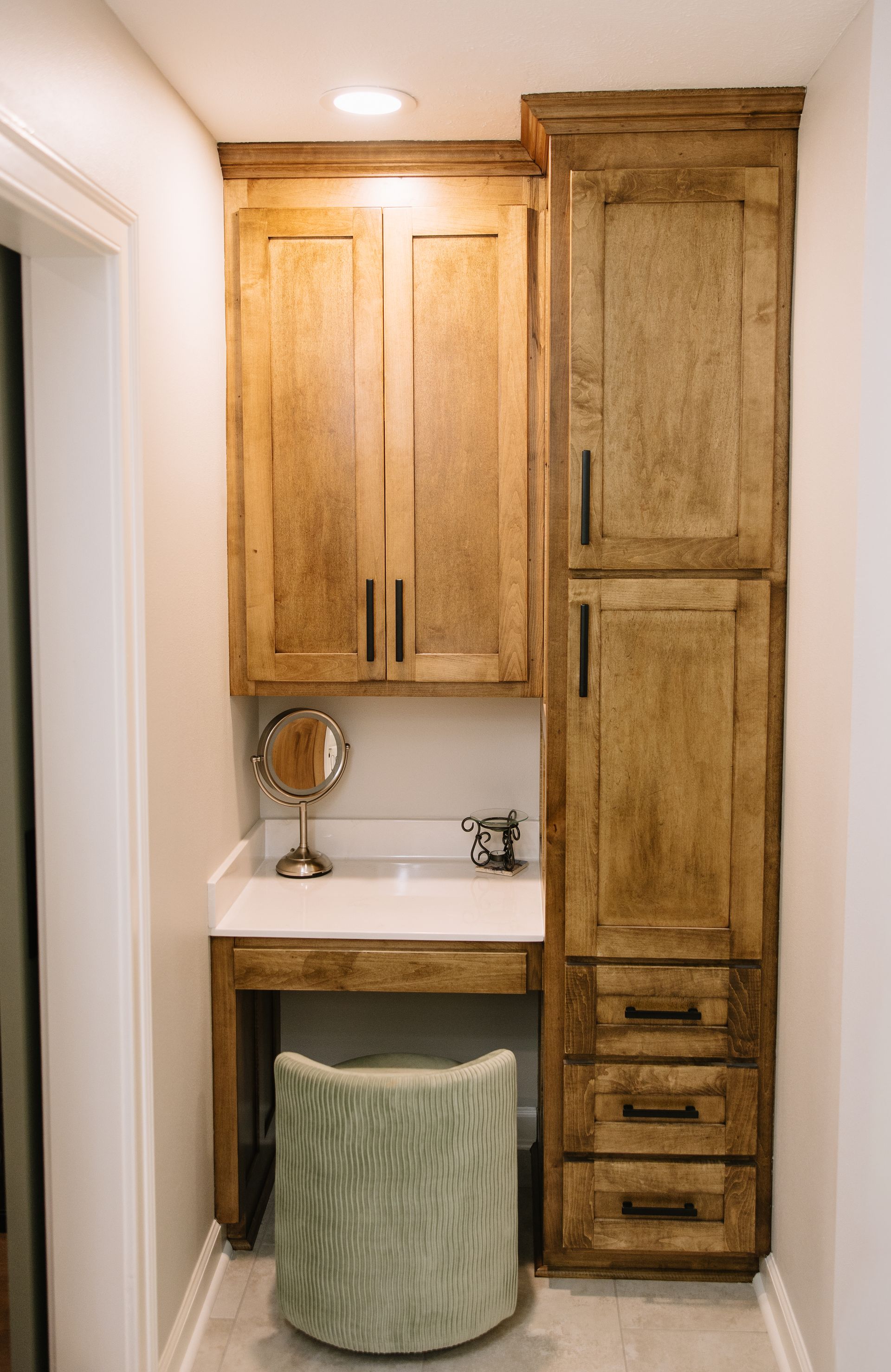 Bright bathroom with a glass shower, white sink, and mirror on the left wall.