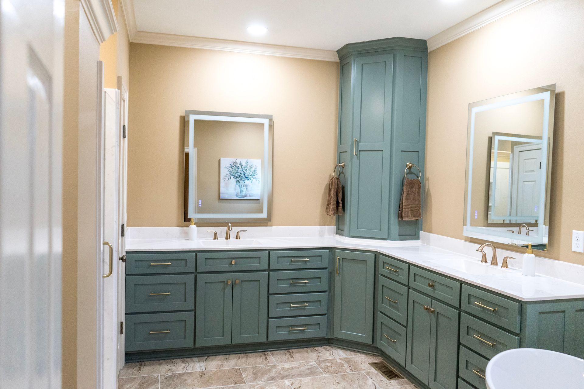 Elegant bathroom vanity with teal cabinets, beige walls, and mirrors above the sinks