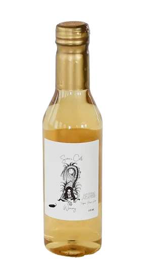 Small clear bottle of pale yellow liquid with a gold cap and a white illustrated label.