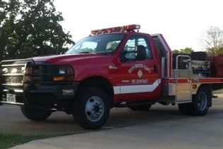 A red fire truck is parked in a driveway