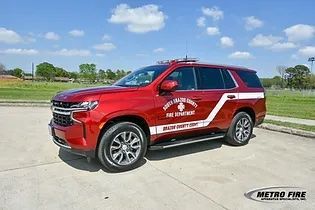 A red chief's vehicle parked in a parking lot.