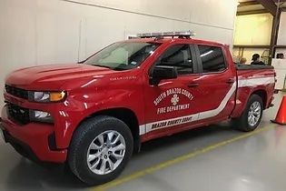 A red chief's vehicle parked in a garage.
