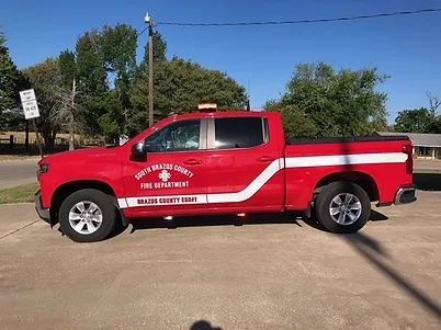 A red chief's vehicle parked on the side of the road.