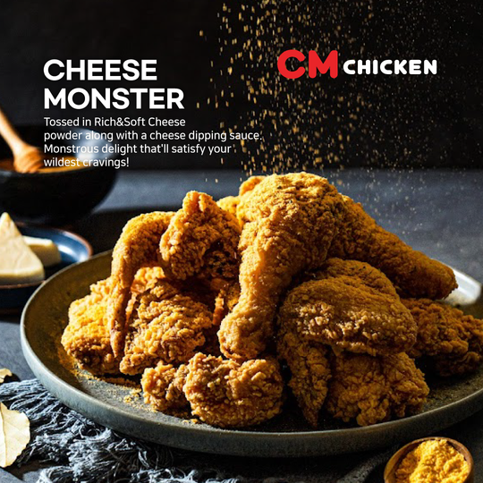 Plate of crispy fried chicken with cheese monster sauce, CM Chicken ad on dark background.