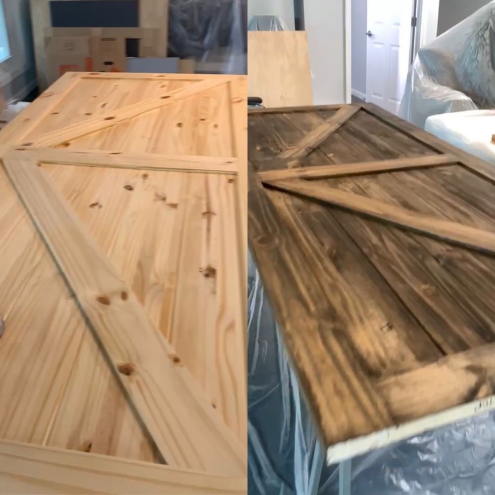 Two wooden cabinet doors, one light pine and one dark stained, leaning together in a workshop