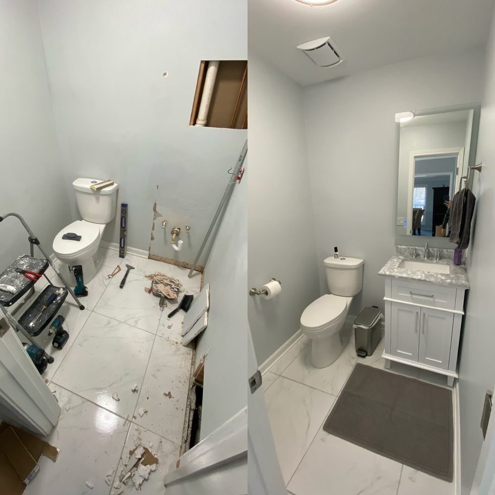 Damaged bathroom with broken wall, debris on floor, toilet, sink, and vanity.