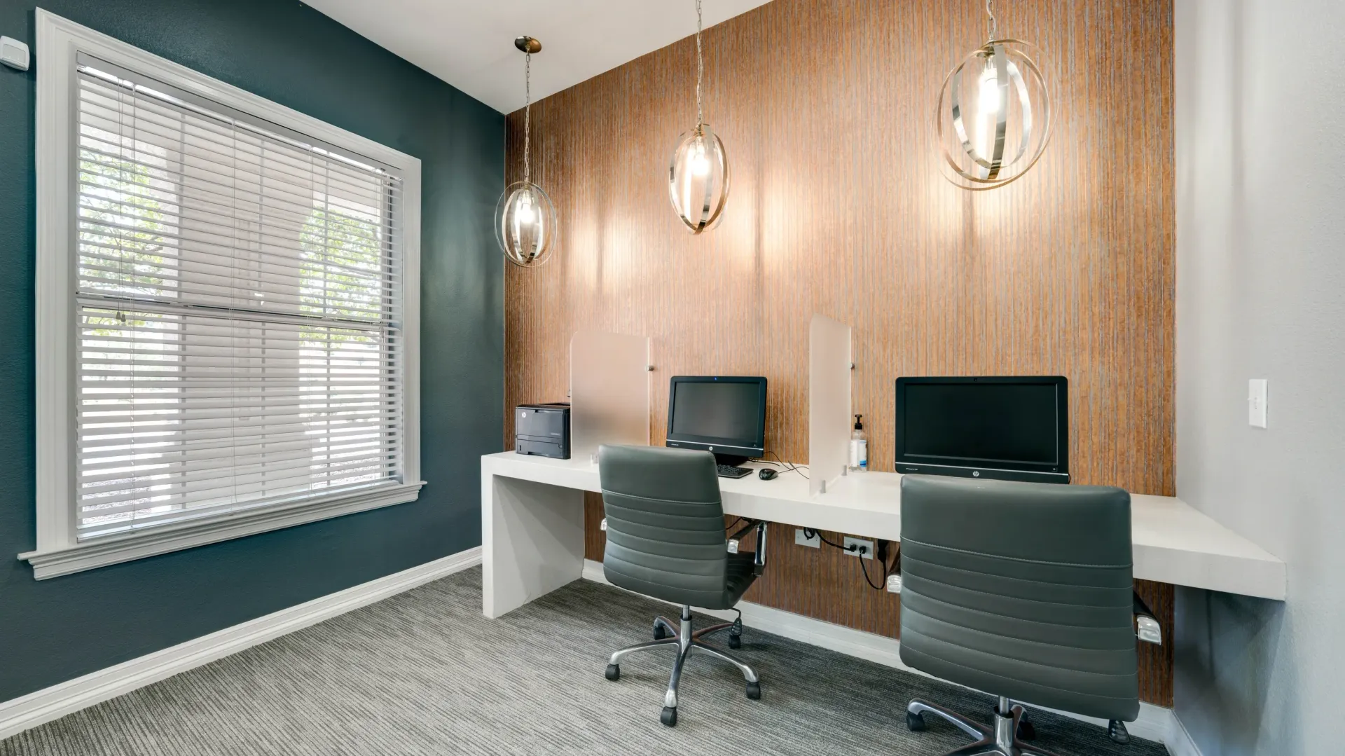 Business center with computers and printer.