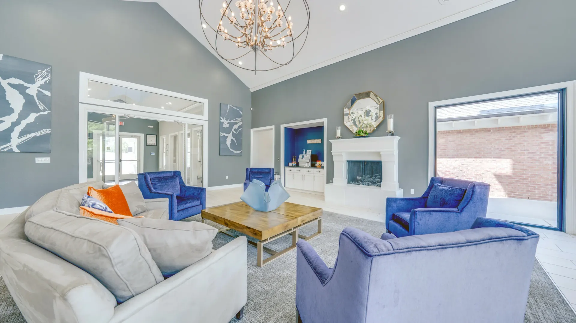 Lobby lounge area with a fireplace, comfortable seating, and a coffee bar.