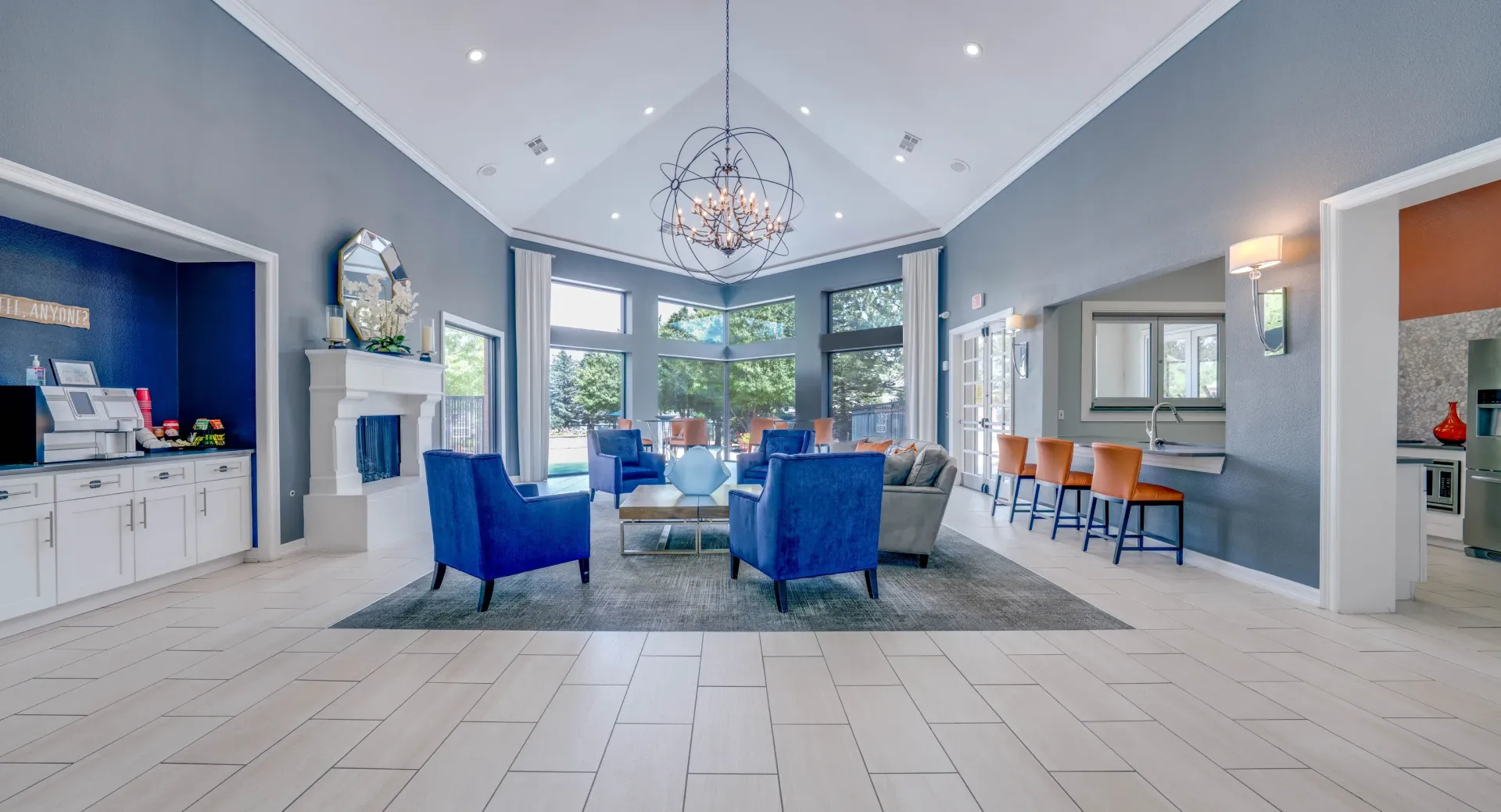 Spacious community lounge with fireplace, seating areas, and bar.