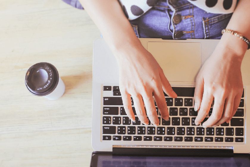 woman typing on a laptop