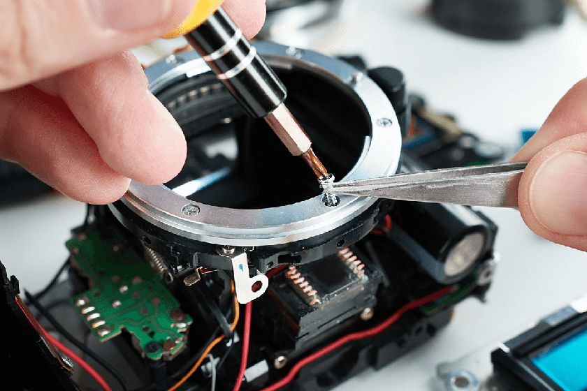 guy repairing a camera
