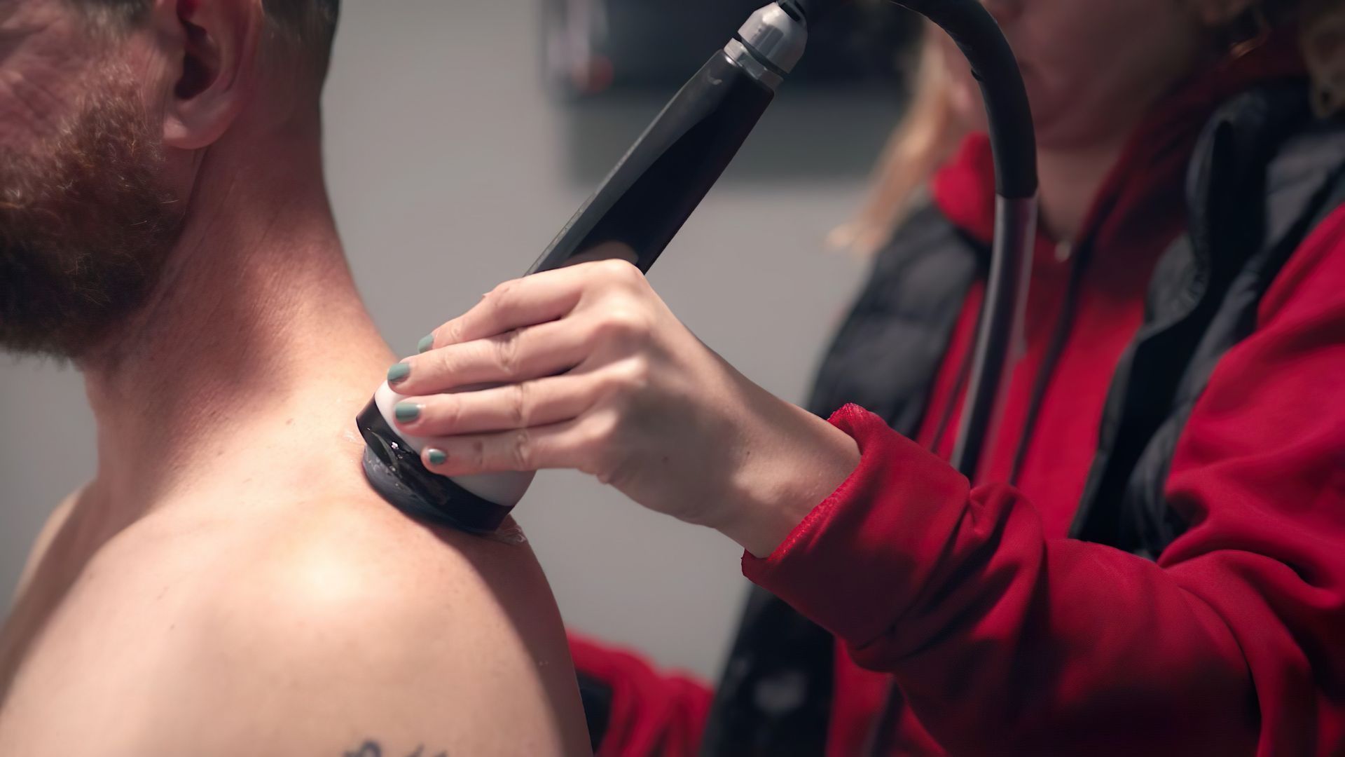 Shockwave therapy applied to an athlete's back at Tampa Bay Physical Therapy