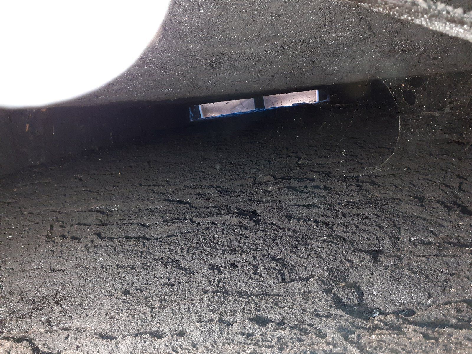 Au fond d'un tunnel sombre, une petite lumière apparaît au-dessus d'un sol à la texture rugueuse.