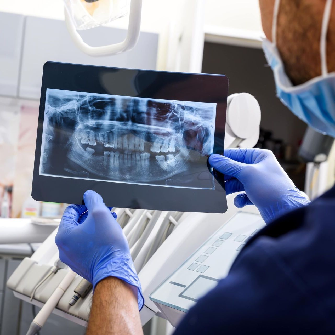 Image of dentist examining X-rays pictures