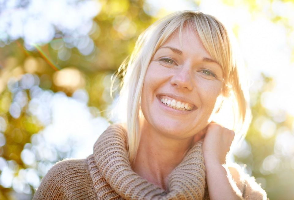 A photo of a blond woman with a beautiful smile.