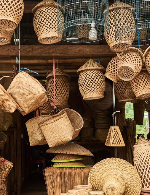 A bunch of baskets hanging from the ceiling in a store.