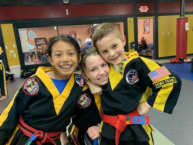 a boy with a demo team patch on his arm